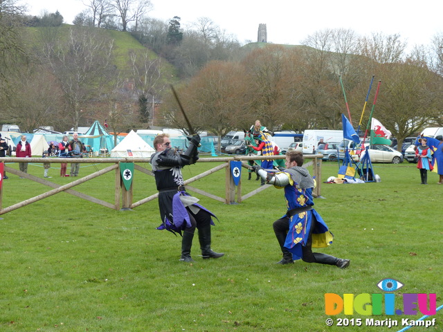 FZ013180 Black and blue knights fighting below Glastonbury Tor